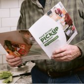 Image of person reading Food Scraps Pickup Program brochure.