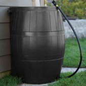 Image of dark brown rain barrel under a gutter.