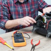 Image of person repairing a vacuum.