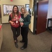 Two female staff at holiday party.