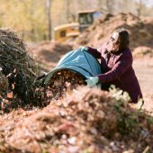 Image of person dropping off leaves at the yard waste site.