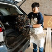 Image of Environmental Center staff unloading holidays lights from a customer's vehicle.