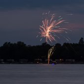 Image of firework show over lake.