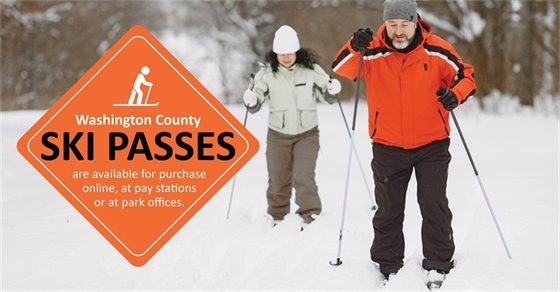 Someone skiing on a winter trail with text that says "Washington County SKI PASSES are available for purchase online, at pay stations or at park offices."