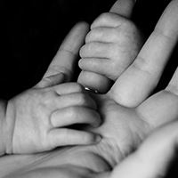 pregnant mother in purple sweater touching belly Opens in new window